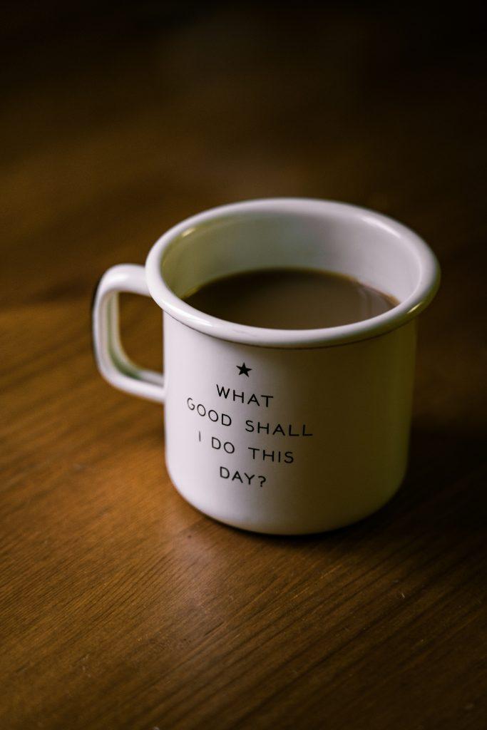 Coffee mug with a motivational message on a wooden table