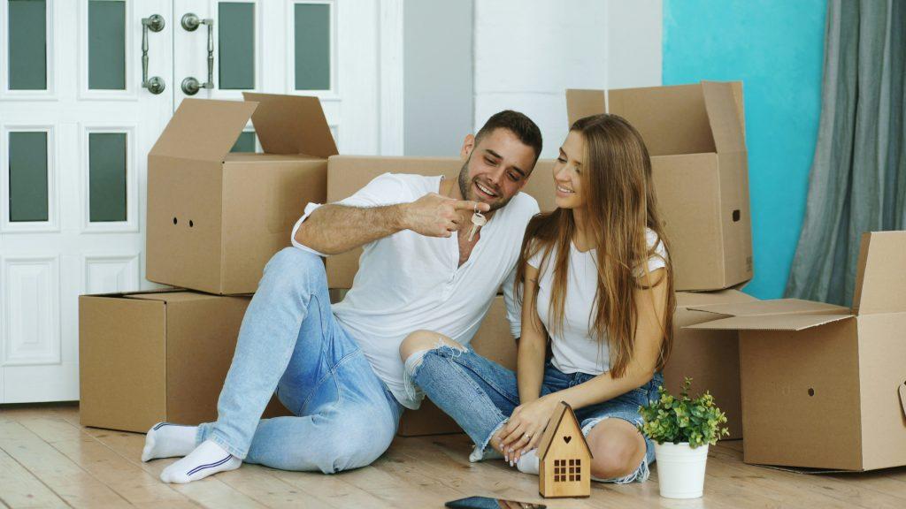 Young couple relaxing among moving boxes in a new home