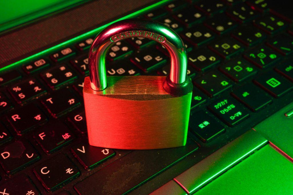 Red padlock resting on a laptop keyboard