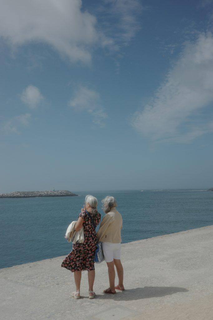 Older couple standing together at a seaside promenade