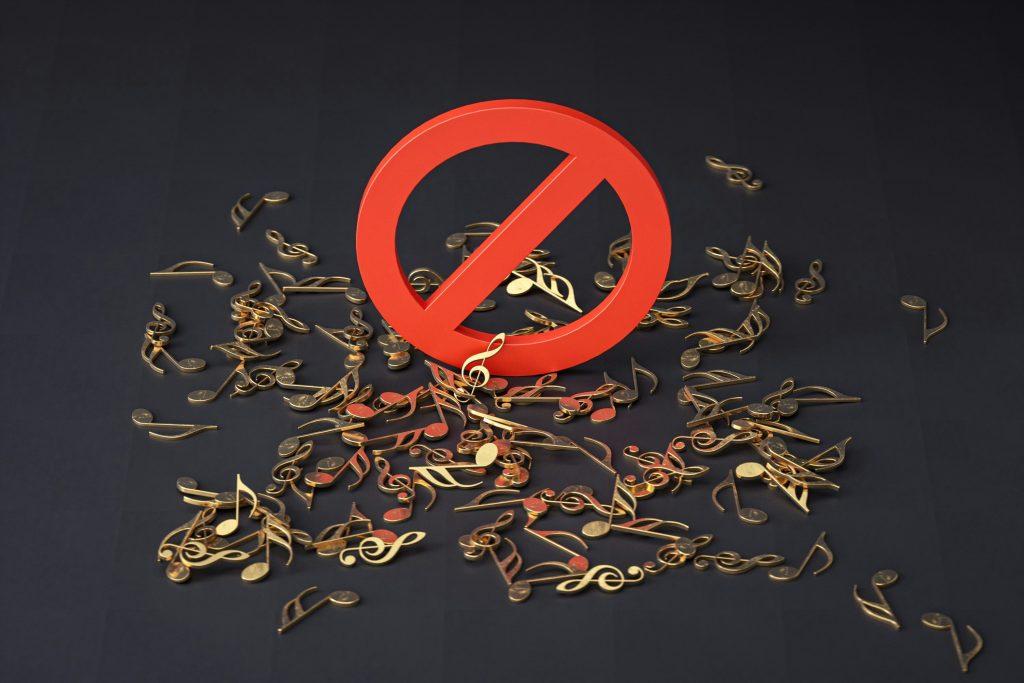 Prohibition sign over scattered music notes